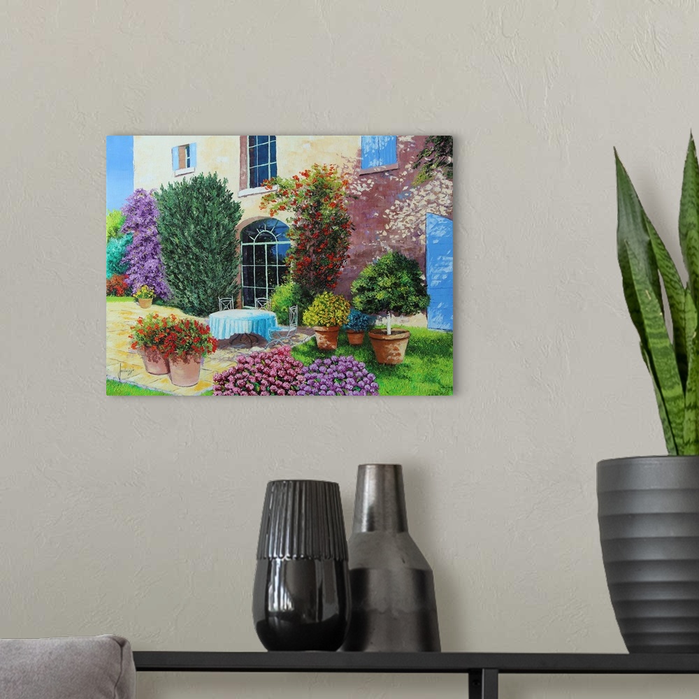 A modern room featuring Colorful contemporary painting of a house surrounded blooming flowers and foliage.