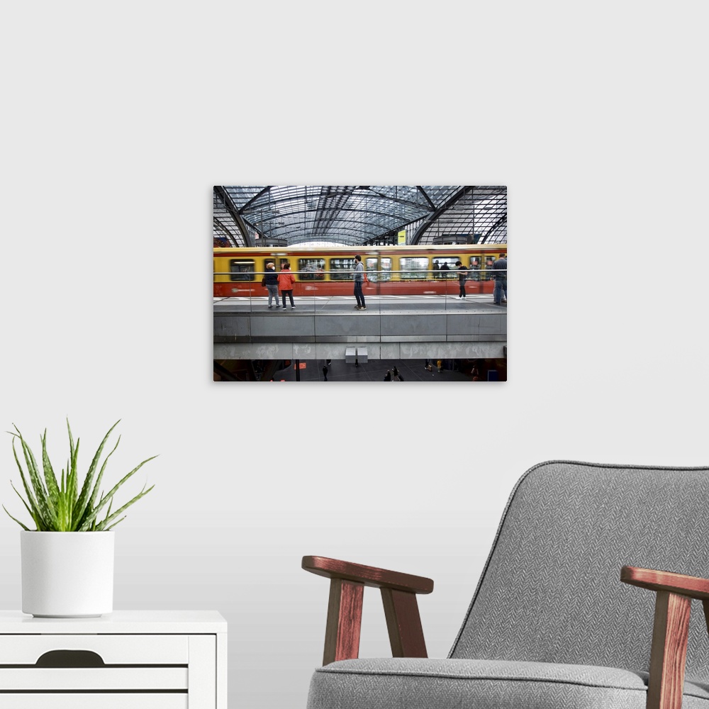 A modern room featuring Germany, Berlin. Passing train at local Central Train Station.
