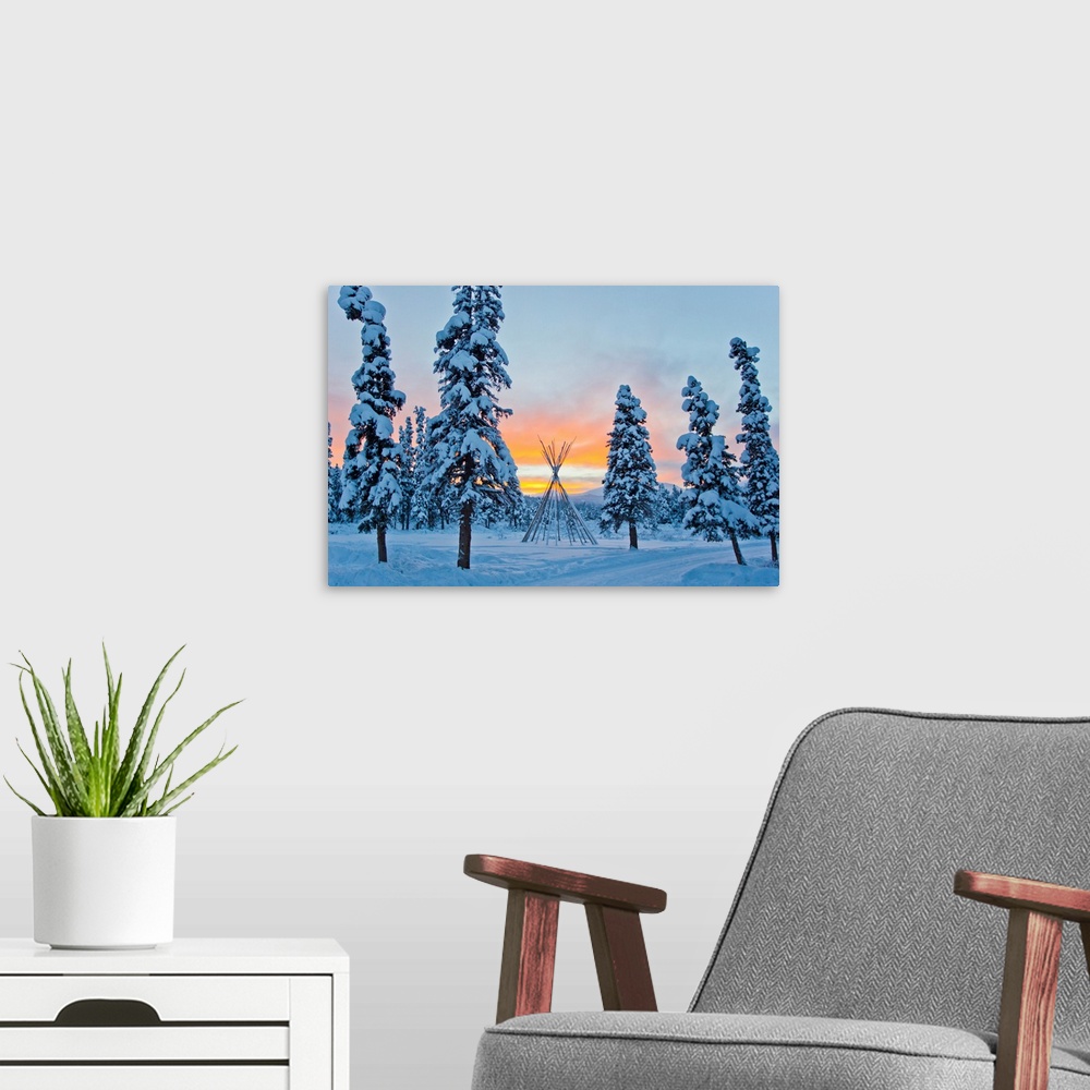 A modern room featuring Orange sky at sunset over snow-covered evergreens and a tee pee form.