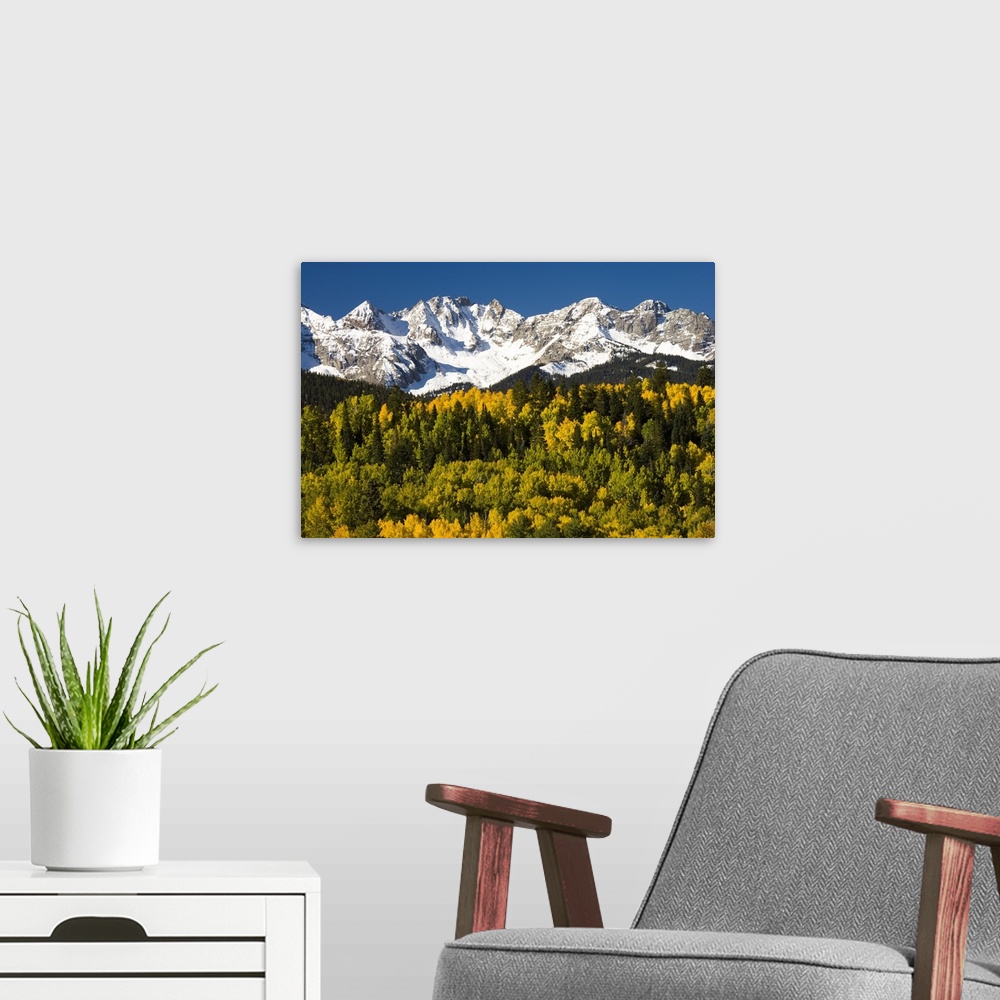 A modern room featuring Fall colors and snow covered peaks, North America