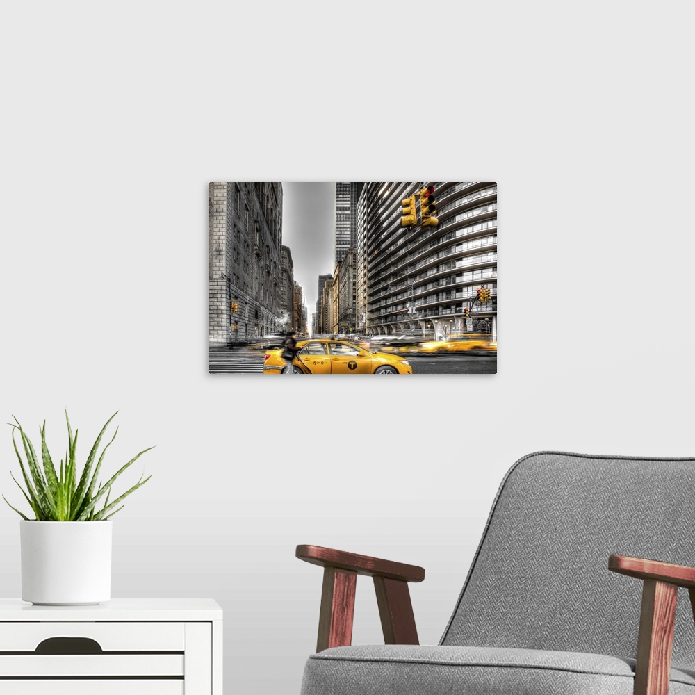 A modern room featuring HDR photograph of a stopped yellow taxi in New York city.