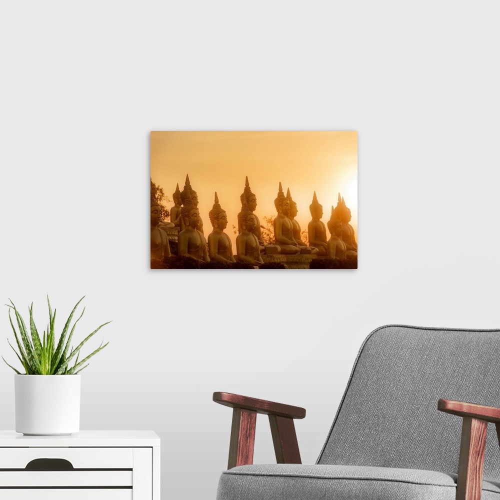 A modern room featuring Sunset in front of rows of buddhas