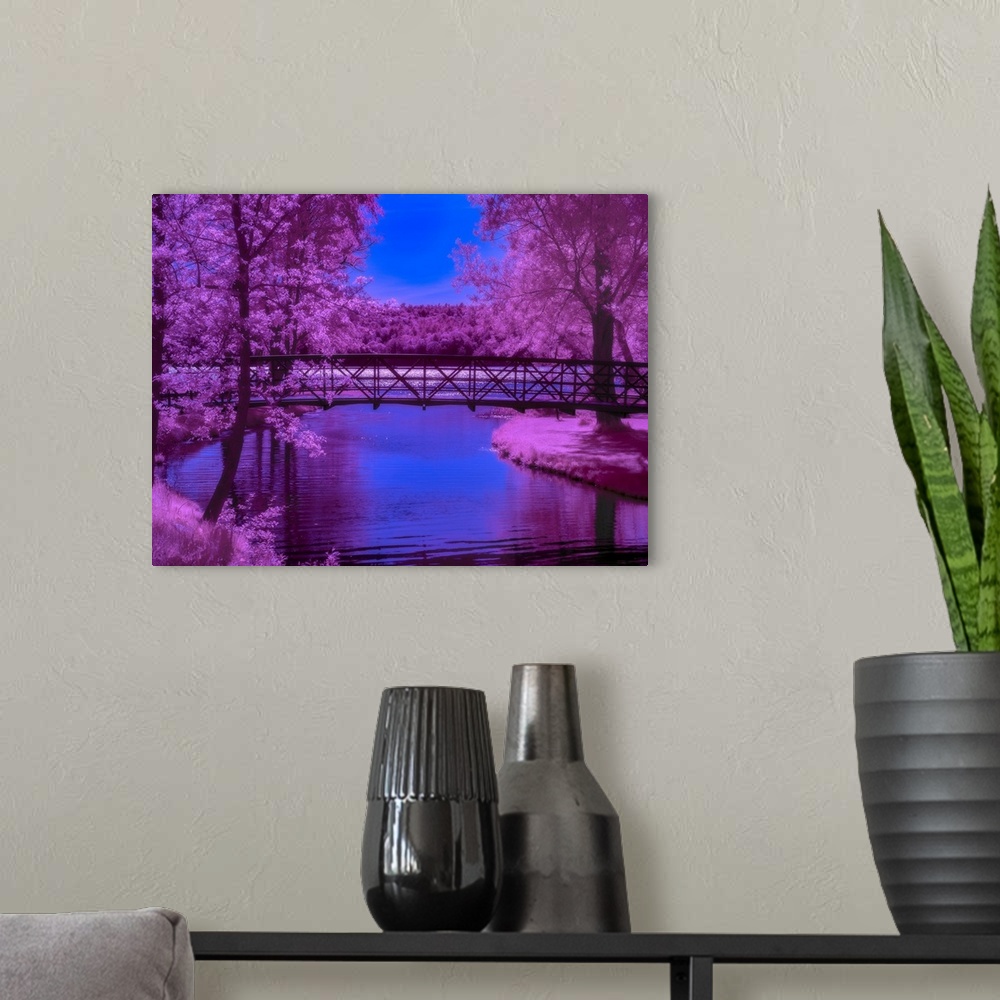 A modern room featuring Surreal photograph of a long bridge over a river lined with bright purple trees.