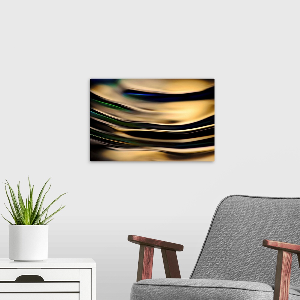 A modern room featuring Abstract photograph of rippling water up close with gold reflections and hints of blue, green, an...