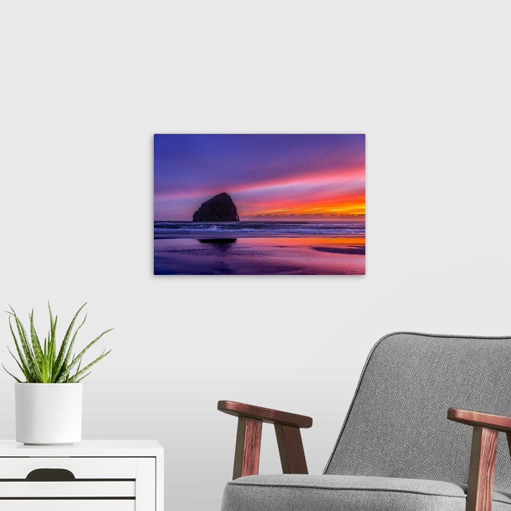 A modern room featuring Vibrant purple sunset over Haystack Rock on the Oregon coast.