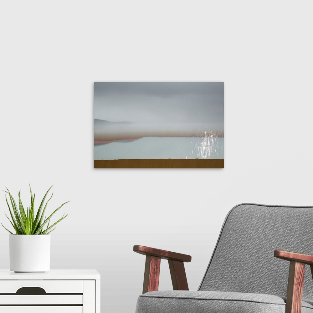 A modern room featuring Abstract image of a landscape with calming colors in shades of blue, brown, pink, and white.
