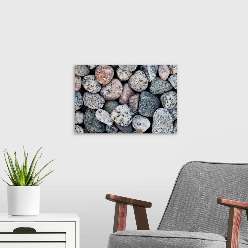 A modern room featuring A close up of pale contemporary granite pebbles on a beach.