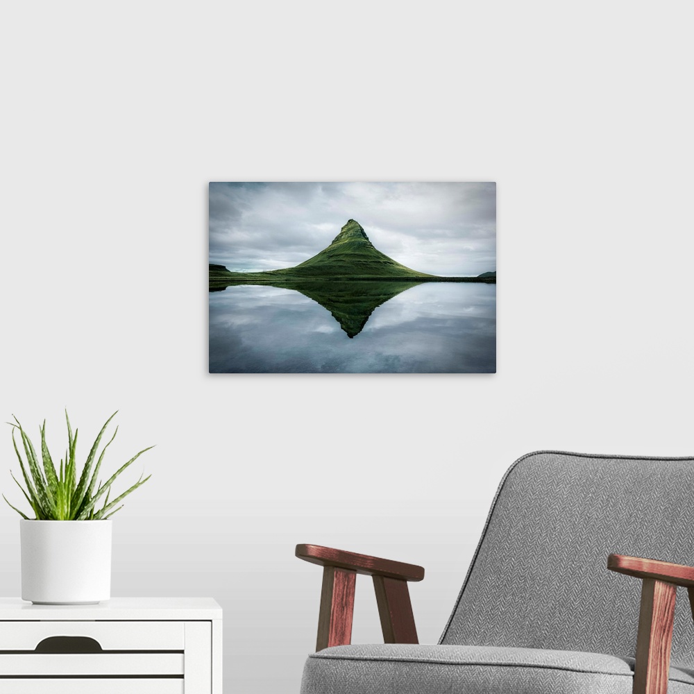 A modern room featuring Fine art photograph of the tall peak of Kirkjufell overlooking a calm lake in Iceland.