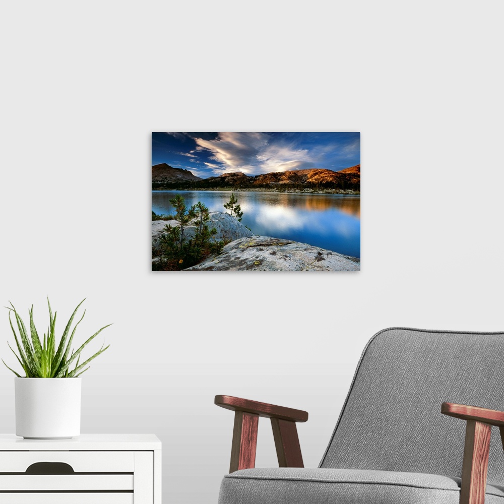 A modern room featuring Clouds and mountains reflect in the surface of the still water in this oversized art for the deco...