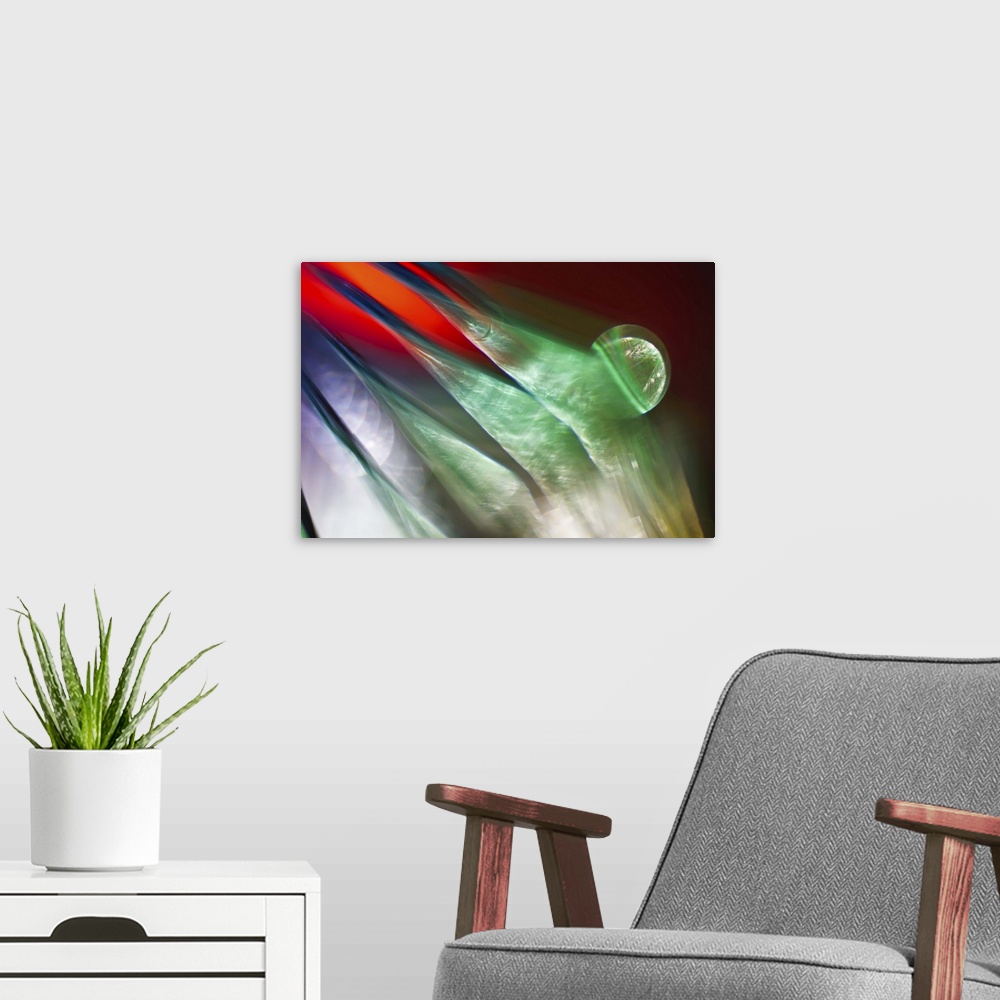 A modern room featuring Abstract photograph of green ridges against red and purple.