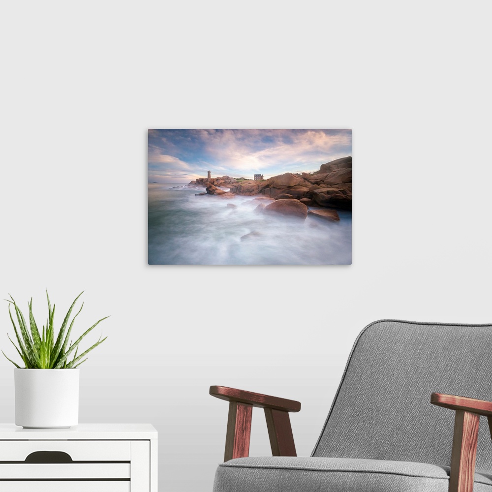 A modern room featuring Fine art photo of misty ocean waters at the rocky coast of France with a lighthouse in the distance.