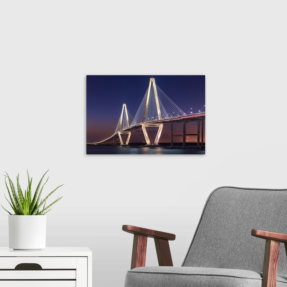A modern room featuring White towers and cables of the Cooper River Bridge in Charleston, South Carolina, at sunset.