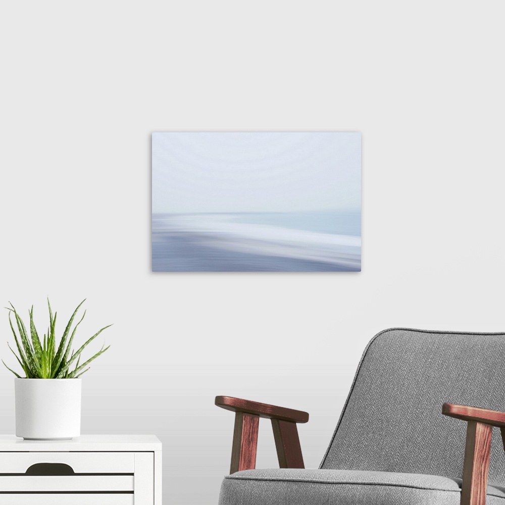 A modern room featuring A calm sea, waves sigh when they reach the misty shore.