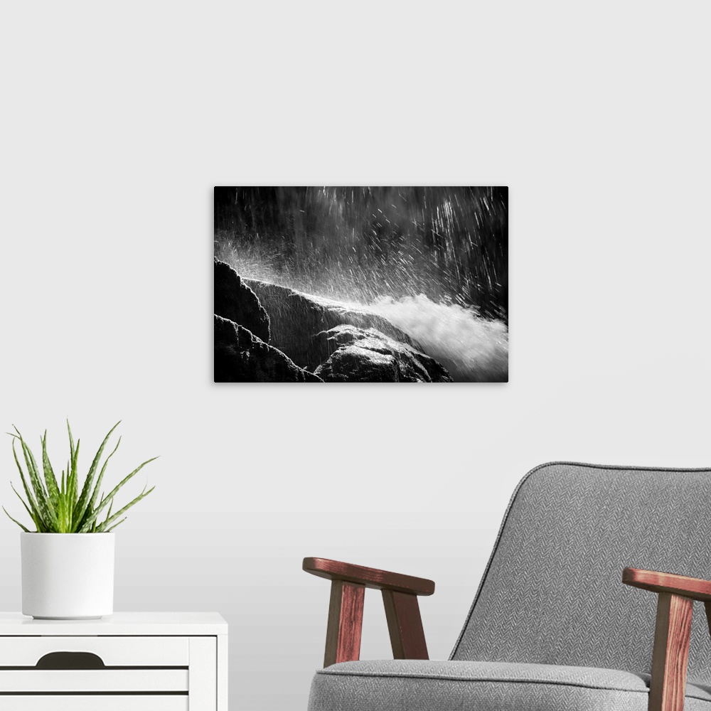 A modern room featuring Black and white photograph of water falling from the top and rushing down rocks.