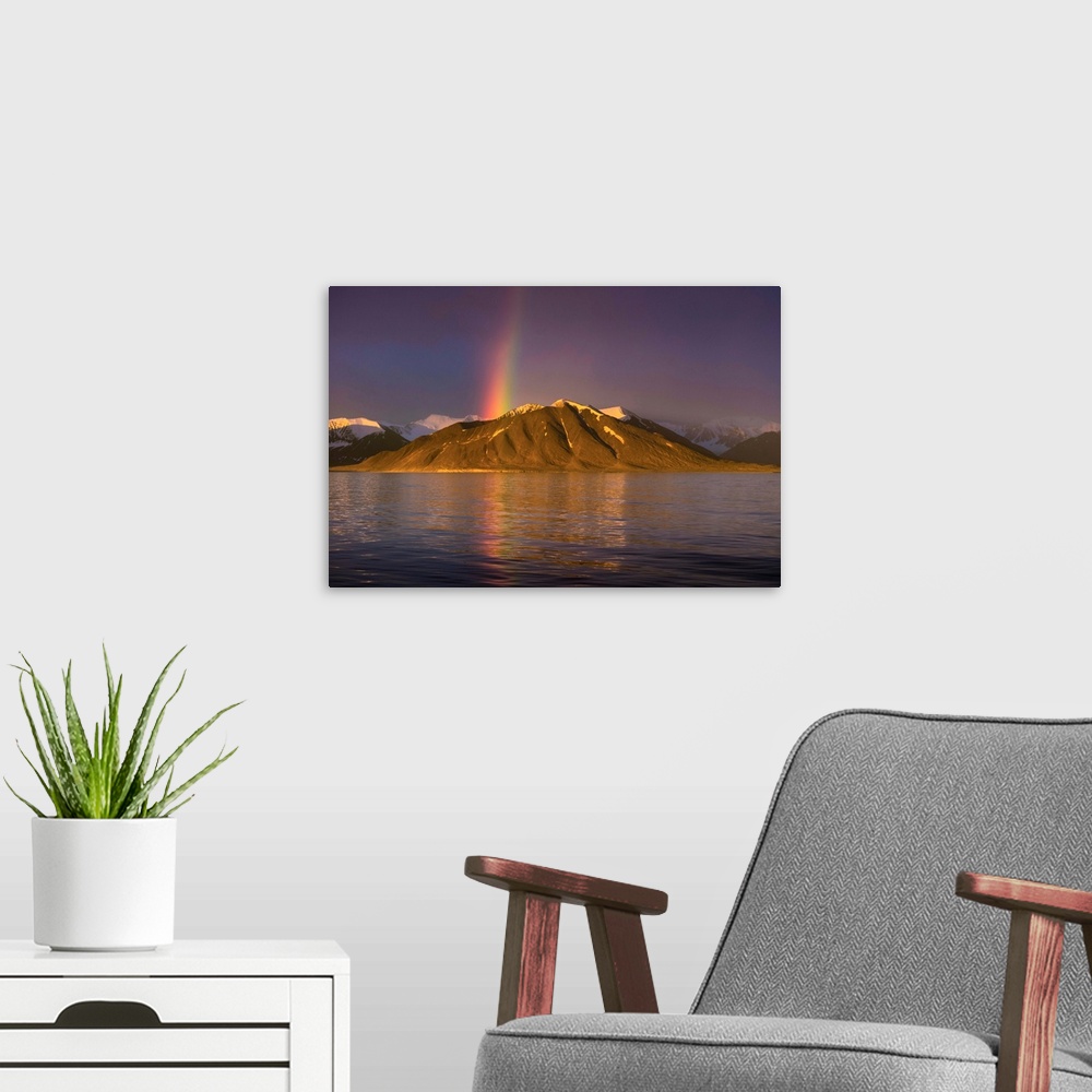 A modern room featuring Fine art photograph of a rainbow over a mountain on the Norwegian coast.