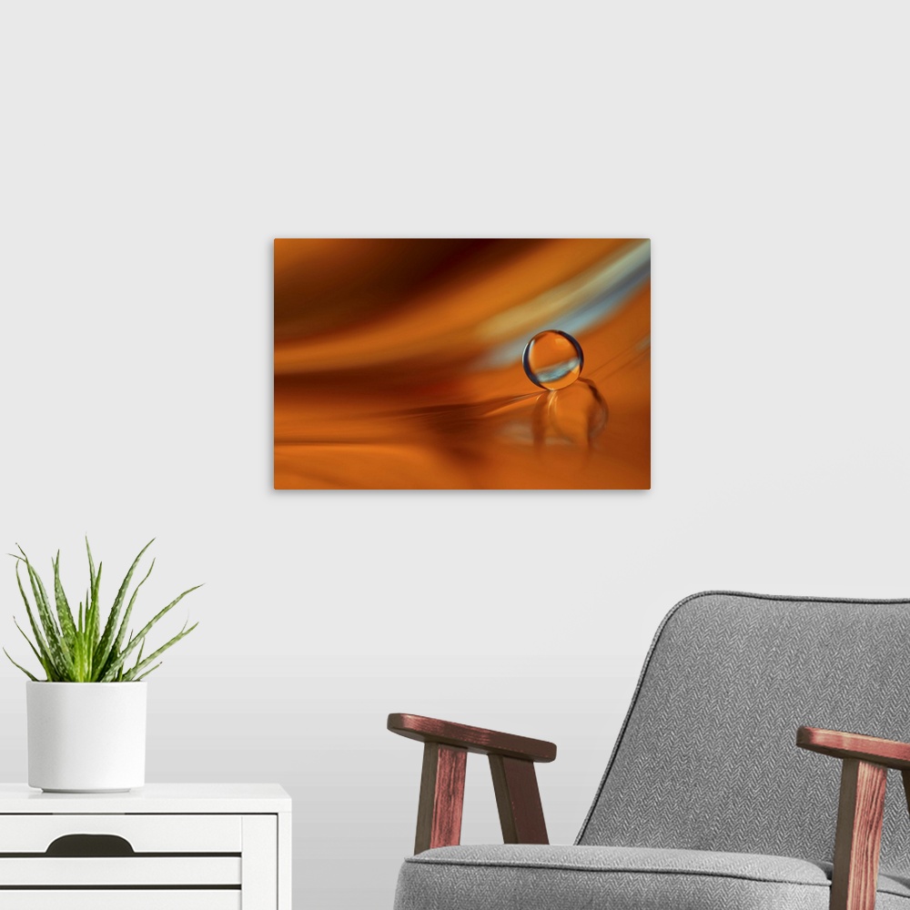A modern room featuring A macro photograph of a water droplet sitting on an orange surface.