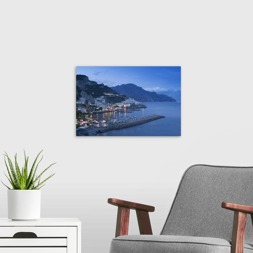 A modern room featuring Big, landscape photograph of lit buildings along a hillside on the Amalfi Coast, in Campania, Ita...