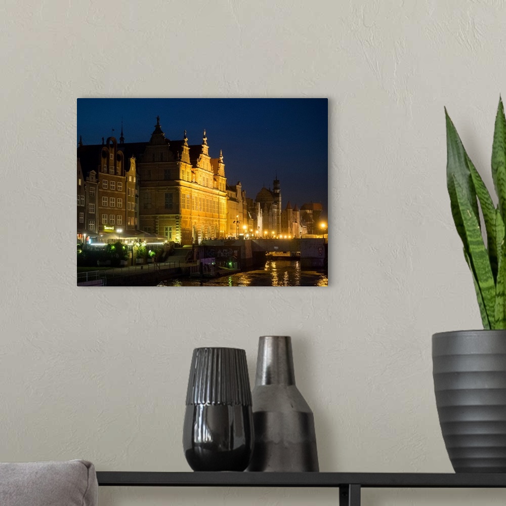A modern room featuring City gate at the waterfront during night, Green Gate, Motlawa River, Gdansk, Poland