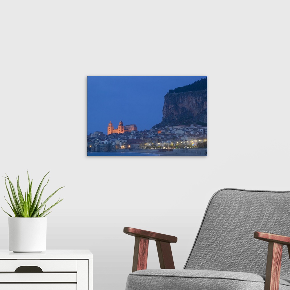A modern room featuring Large photograph includes a lively town on the coast of this famous island in Europe brightly shi...