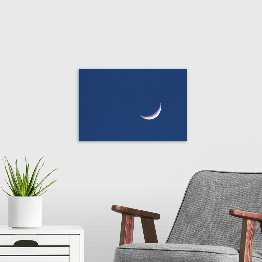 A modern room featuring Crescent moon in deep blue sky
