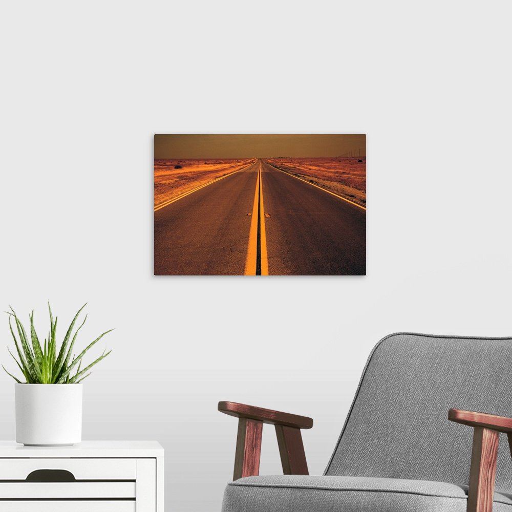 A modern room featuring Distance view of empty road in desert at evening