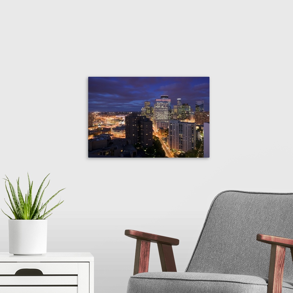 A modern room featuring This photograph is taken of downtown Minneapolis at night from atop a building and looking straig...