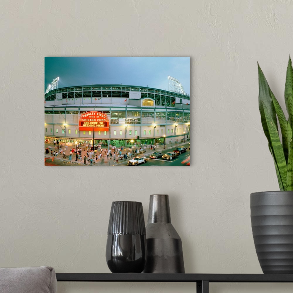 A modern room featuring A horizontal photograph showing an entrance and sign to Chicagoos beloved baseball stadium.