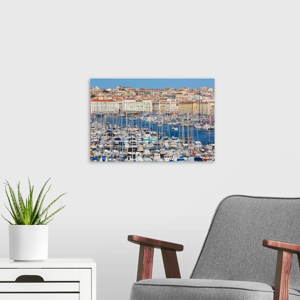 A modern room featuring Marseille, Provence-Alpes-Cote d'Azur, France. High view down onto Vieux-Port, the Old Port, and ...