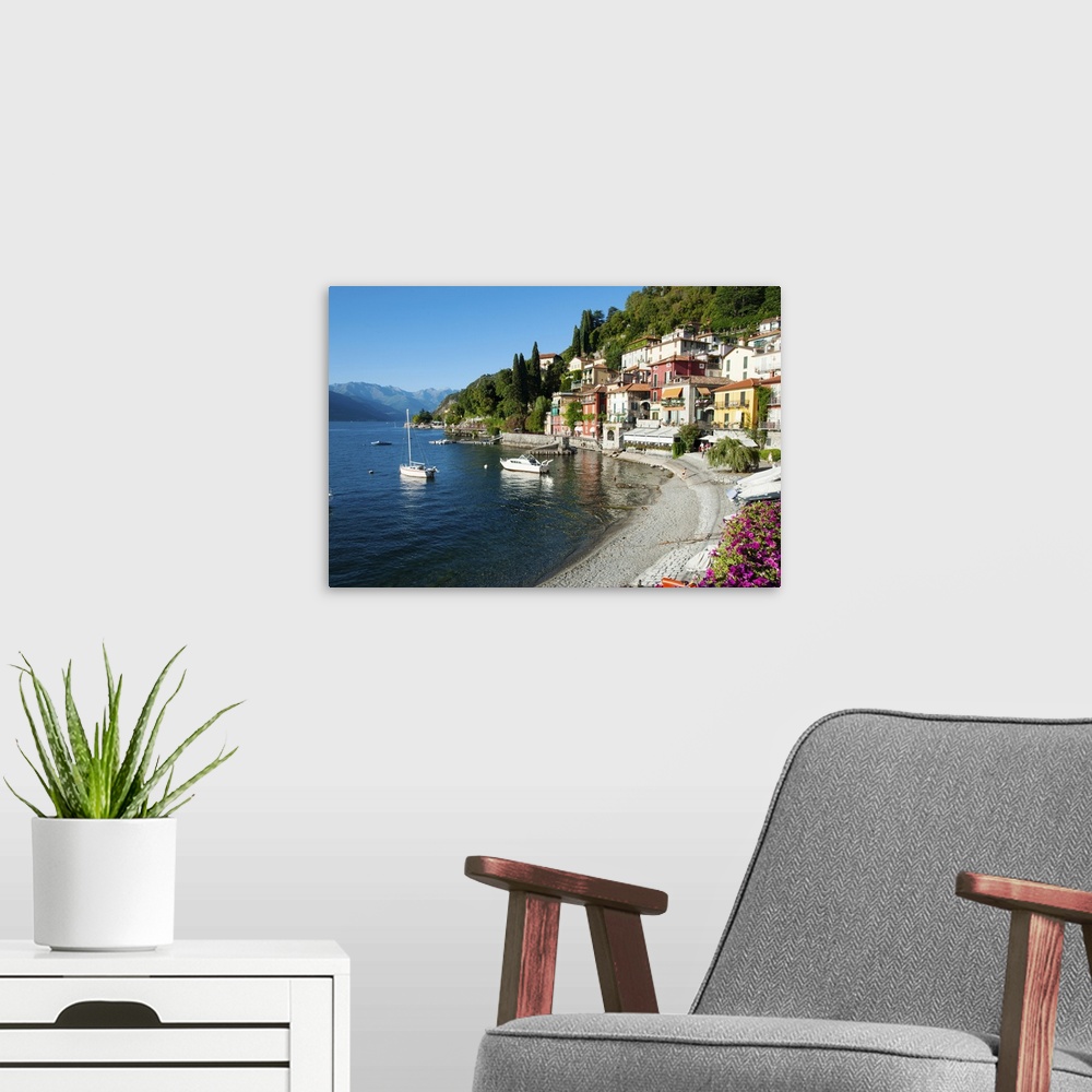 A modern room featuring Houses at waterfront with boats on Lake Como, Varenna, Lombardy, Italy