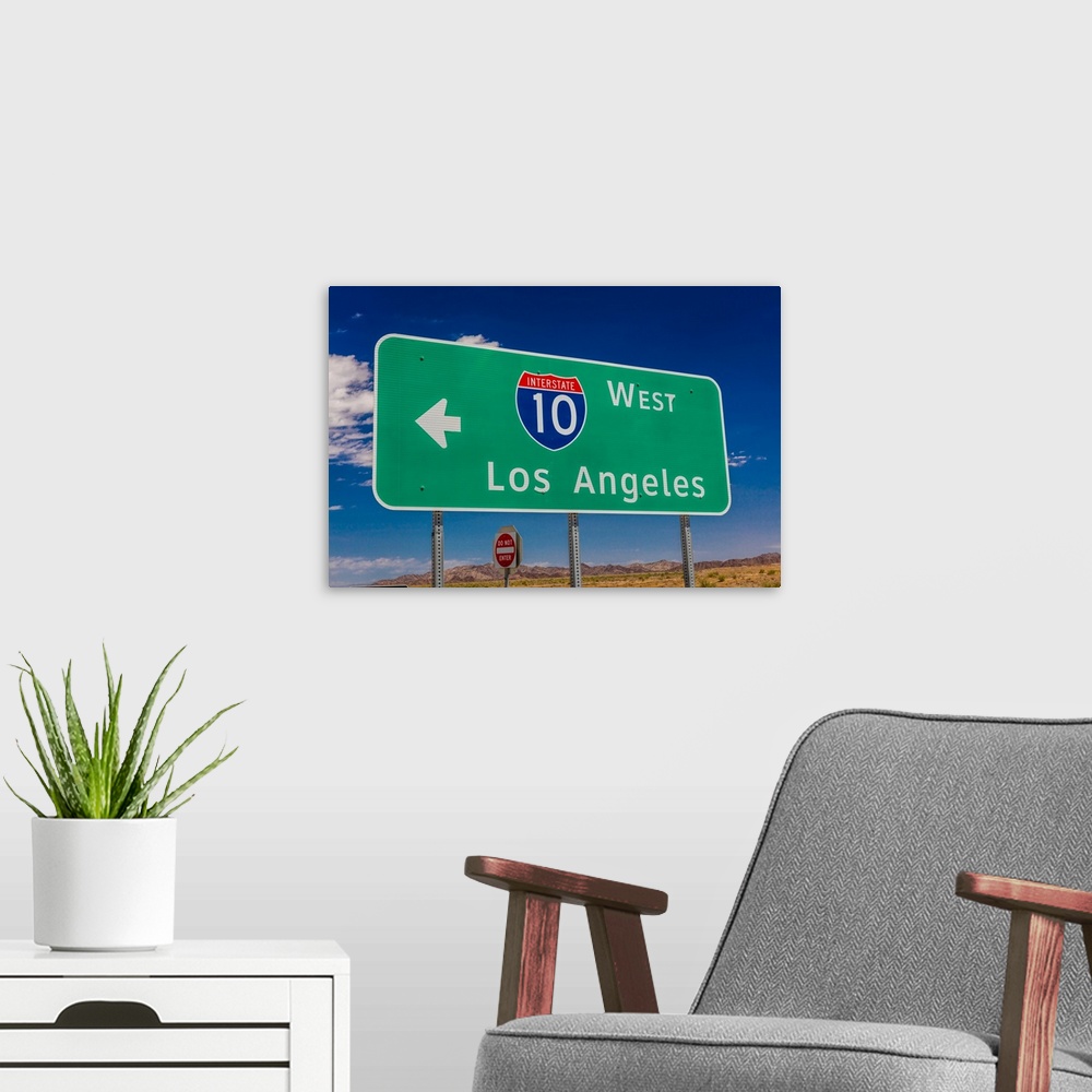 A modern room featuring Interstate 10 highway signs to and from phoenix,arizona and los angeles, california.