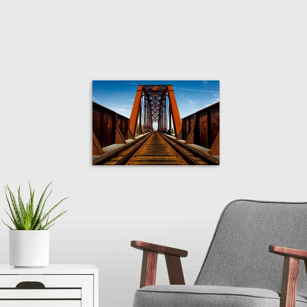A modern room featuring Iron railroad bridge over water, texas.
