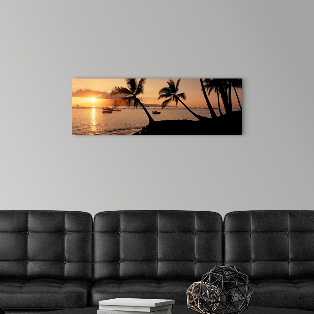 A modern room featuring Panoramic photograph of a colorful sunset in the town of Lahaina on the island of Maui in Hawaii....