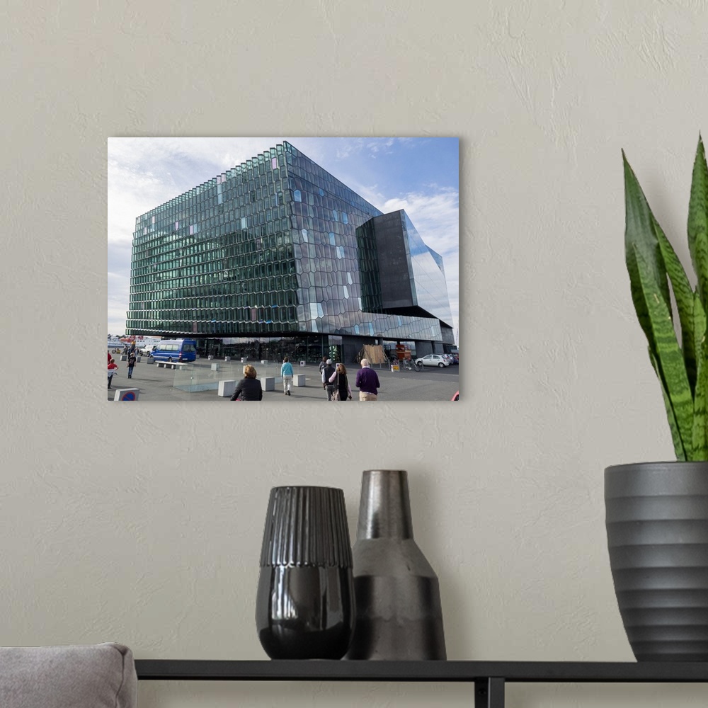 A modern room featuring Modern cube glass building against cloudy sky, Harpa Concert Hall, Reykjavik, Iceland