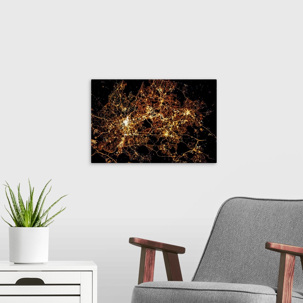 A modern room featuring Night time satellite image of a city in England, United Kingdom