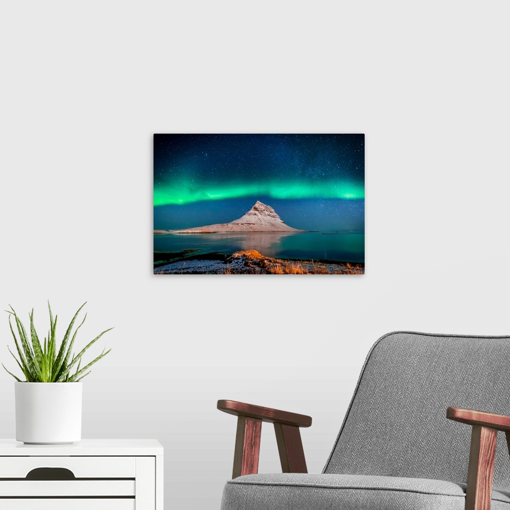 A modern room featuring Aurora borealis or northern lights with the milky way galaxy, mt. Kirkjufell, grundarfjordur, sna...