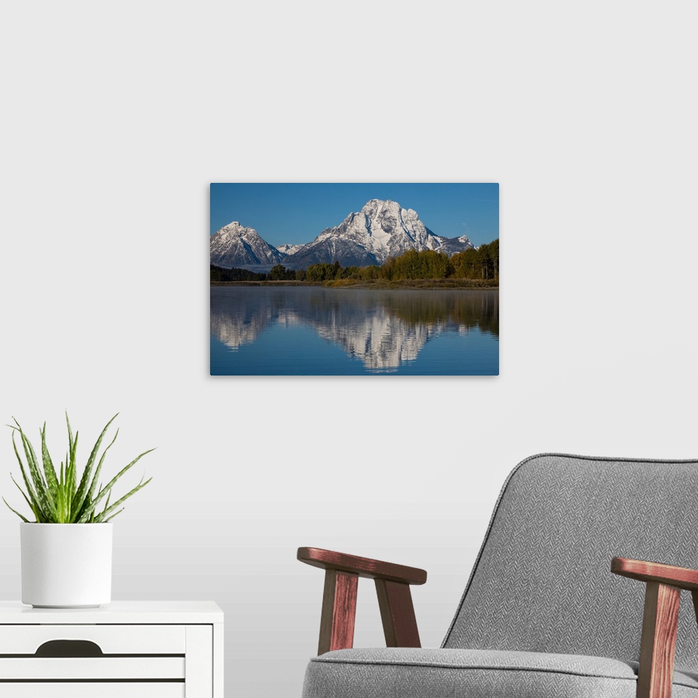 A modern room featuring Reflection of mountain and trees on water, Teton Range, Grand Teton National Park, Wyoming, USA
