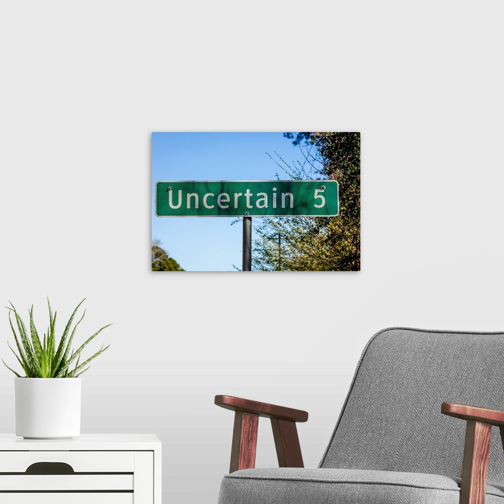A modern room featuring Road sign to uncertain, texas.
