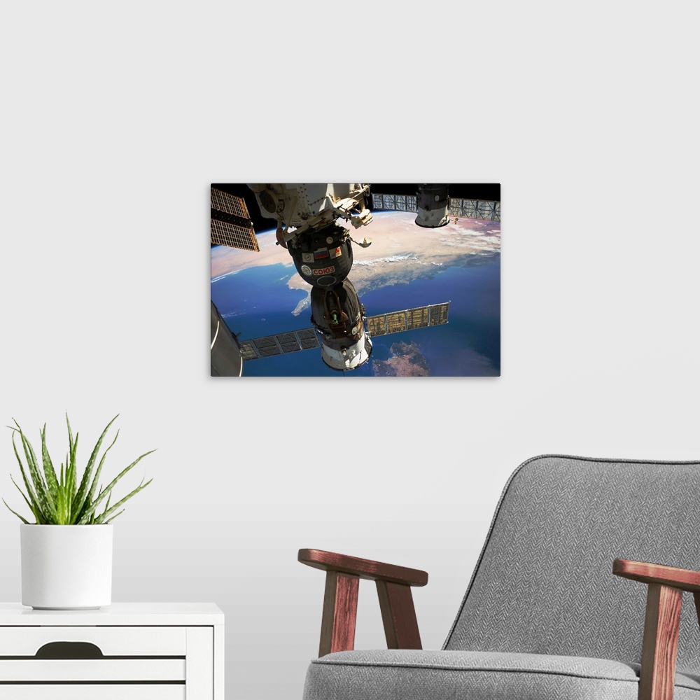 A modern room featuring Satellite in space with view of Italy and Africa on Earth