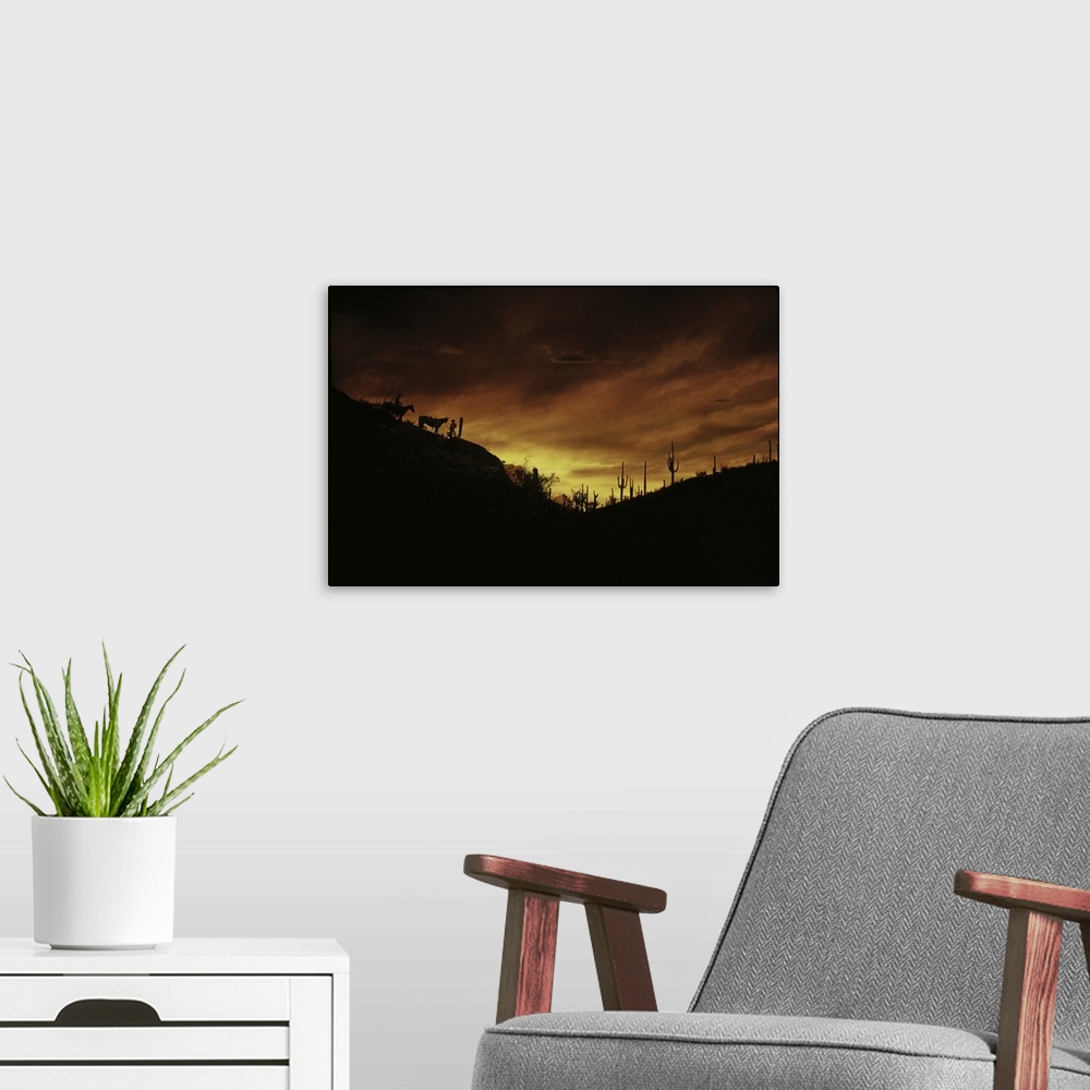 A modern room featuring Two cowboys and their horses are silhouetted against the fading sunlight, along with tall cactuse...
