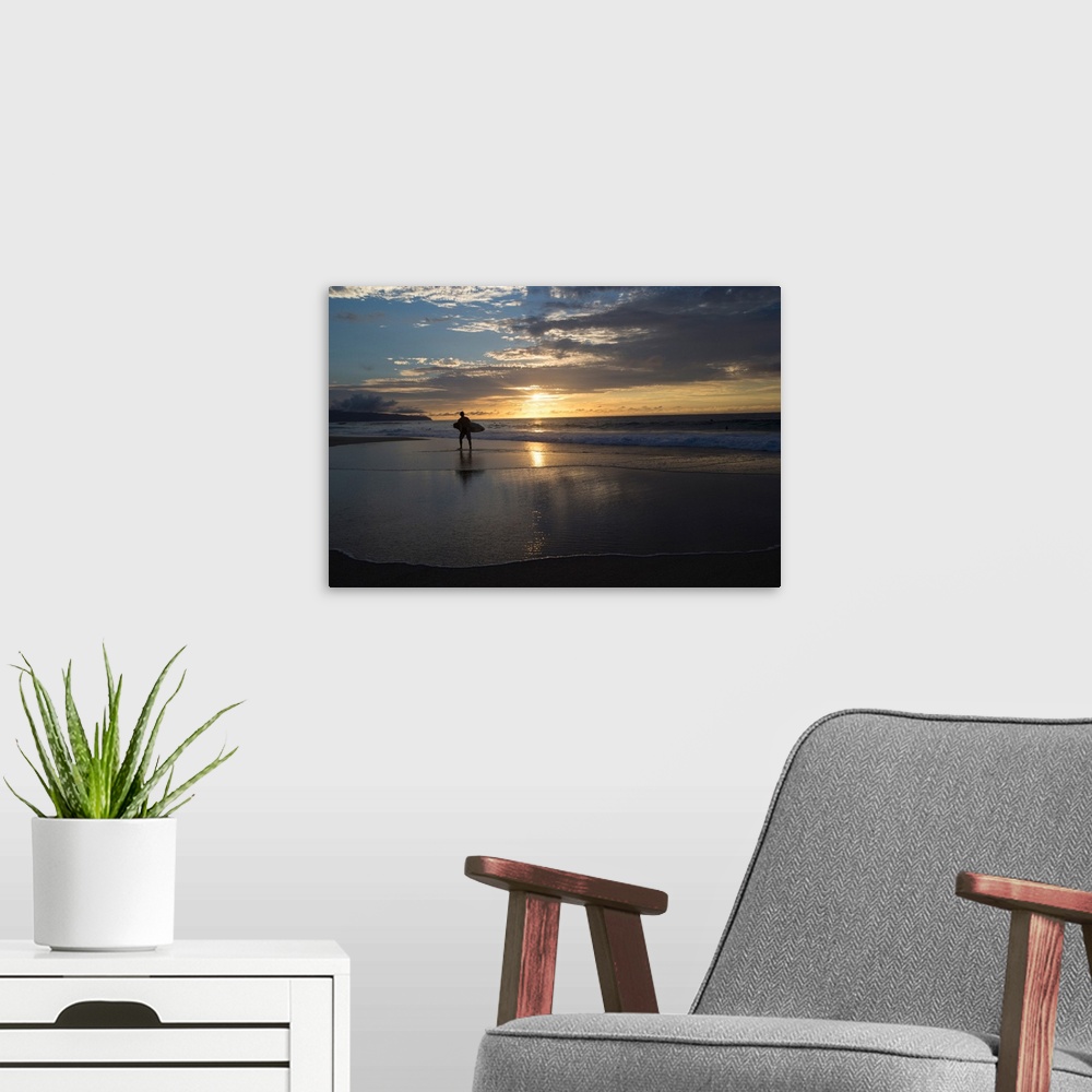 A modern room featuring Surfer walking on the beach at sunset, Hawaii, USA