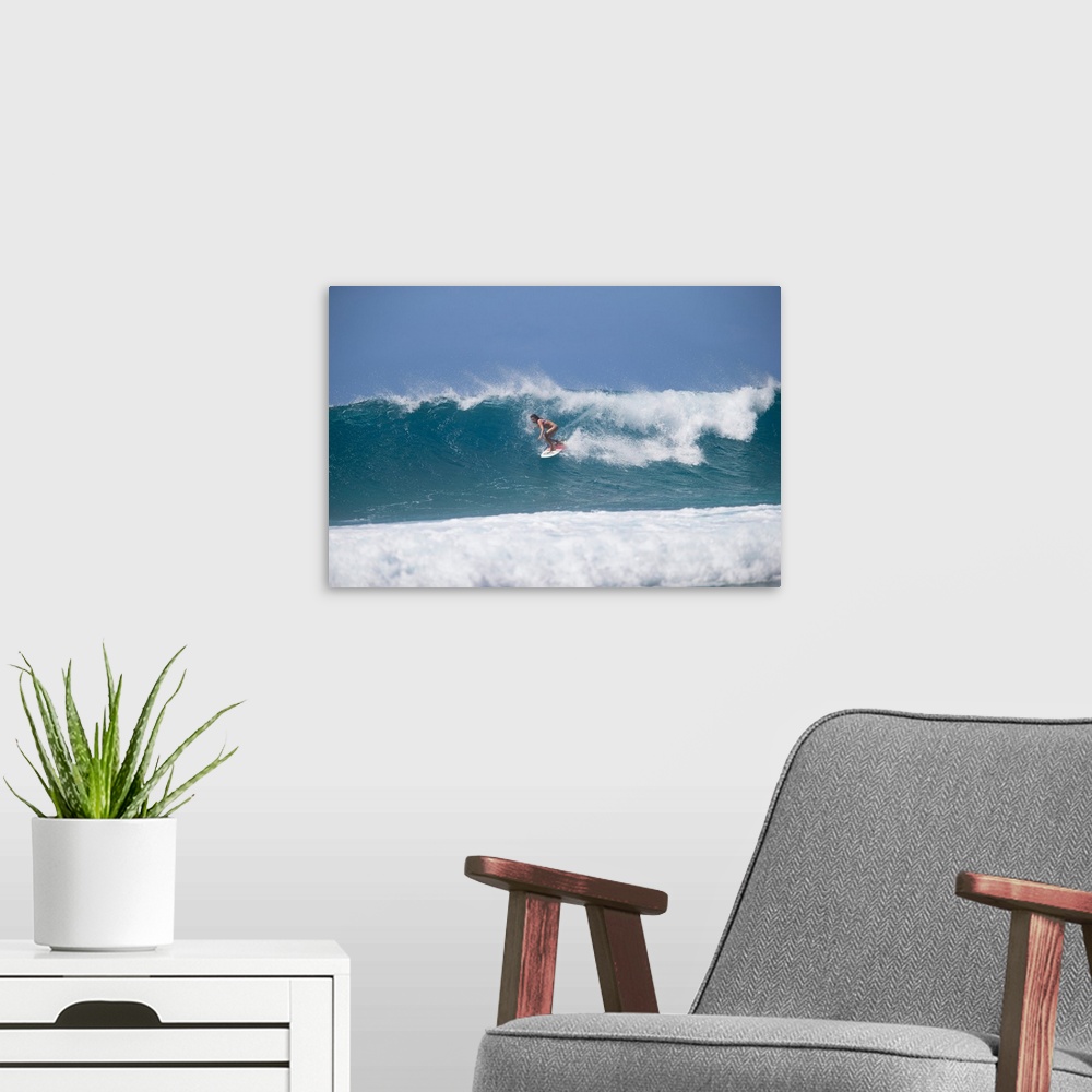 A modern room featuring Woman surfing down a wave on beach, Hawaii, USA