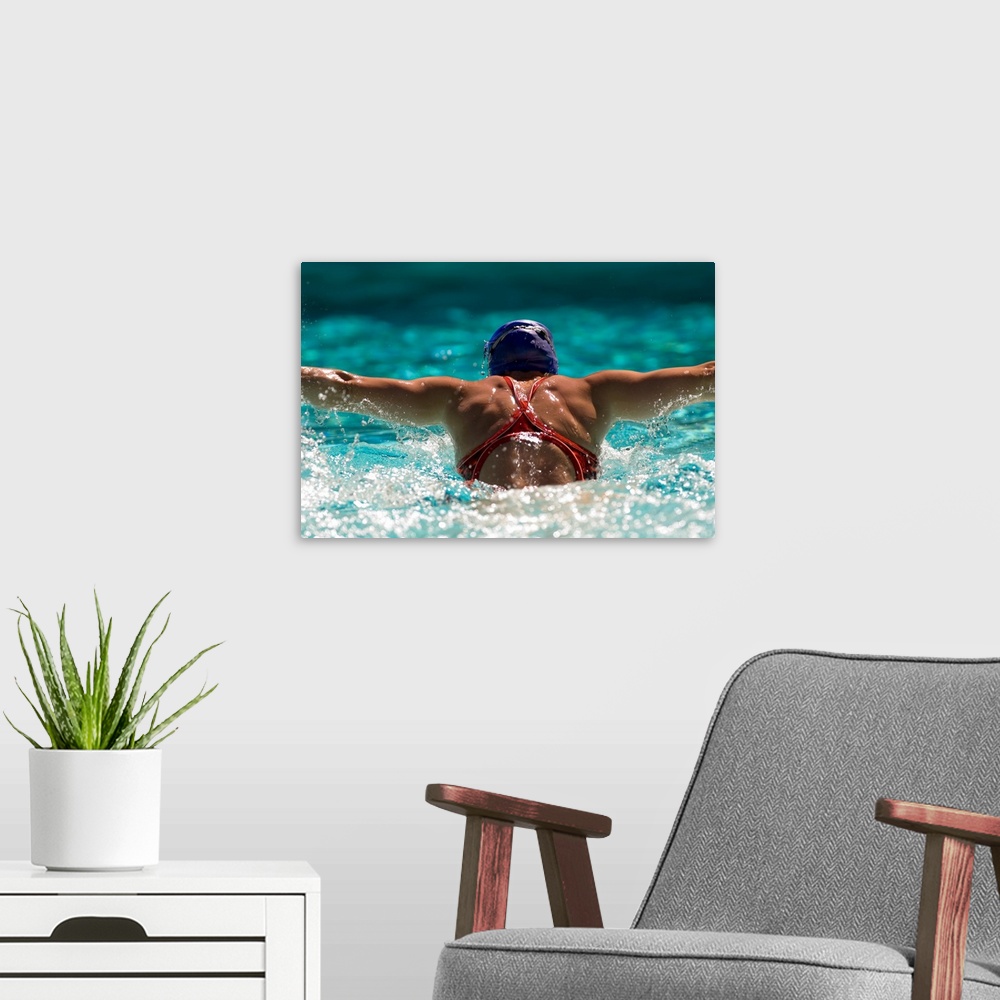 A modern room featuring Rear view of a woman swimming the butterfly stroke in a swimming pool, bainbridge island, washing...