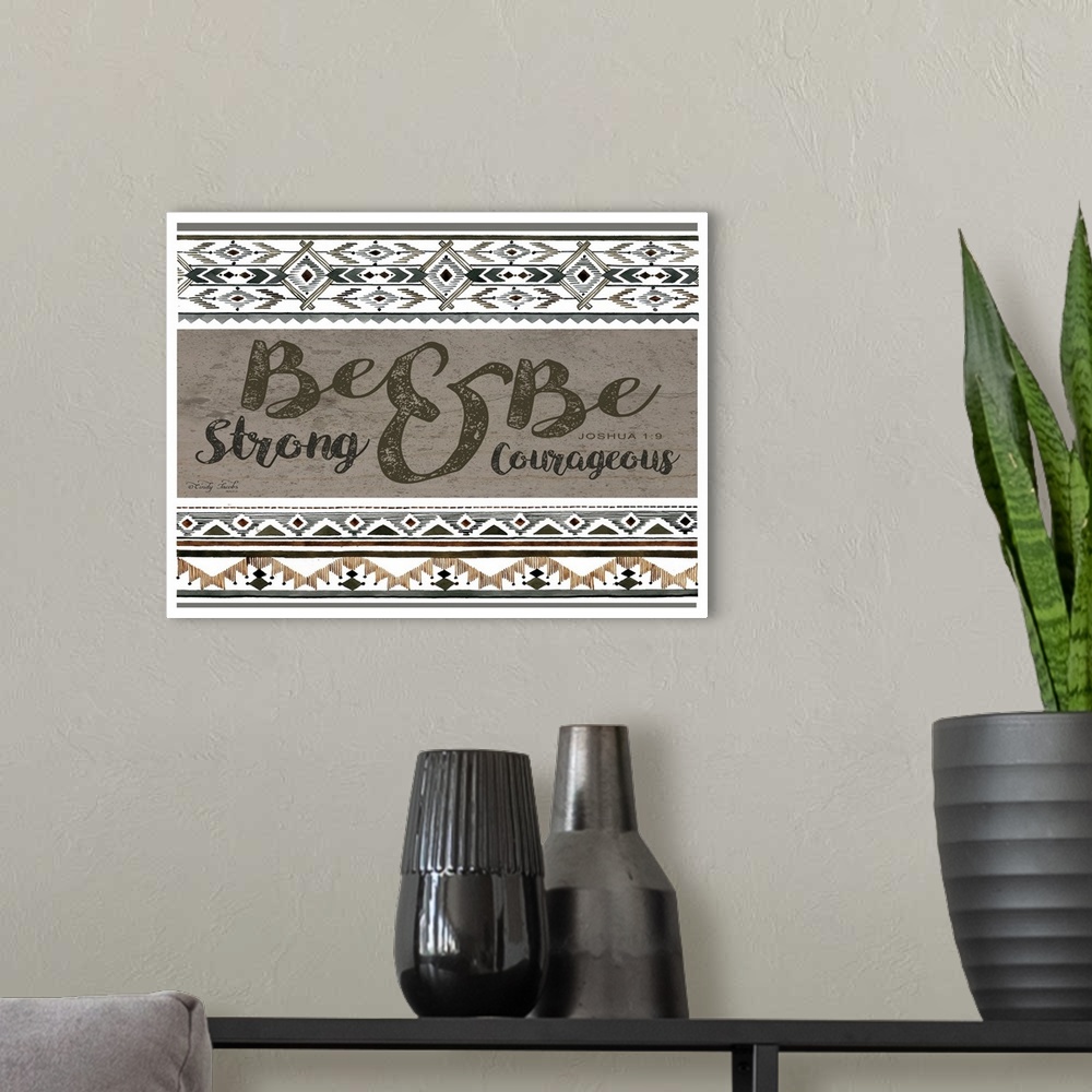 A modern room featuring Decorative artwork featuring geometric southwestern designs and the Joshua 1:9 scripture.