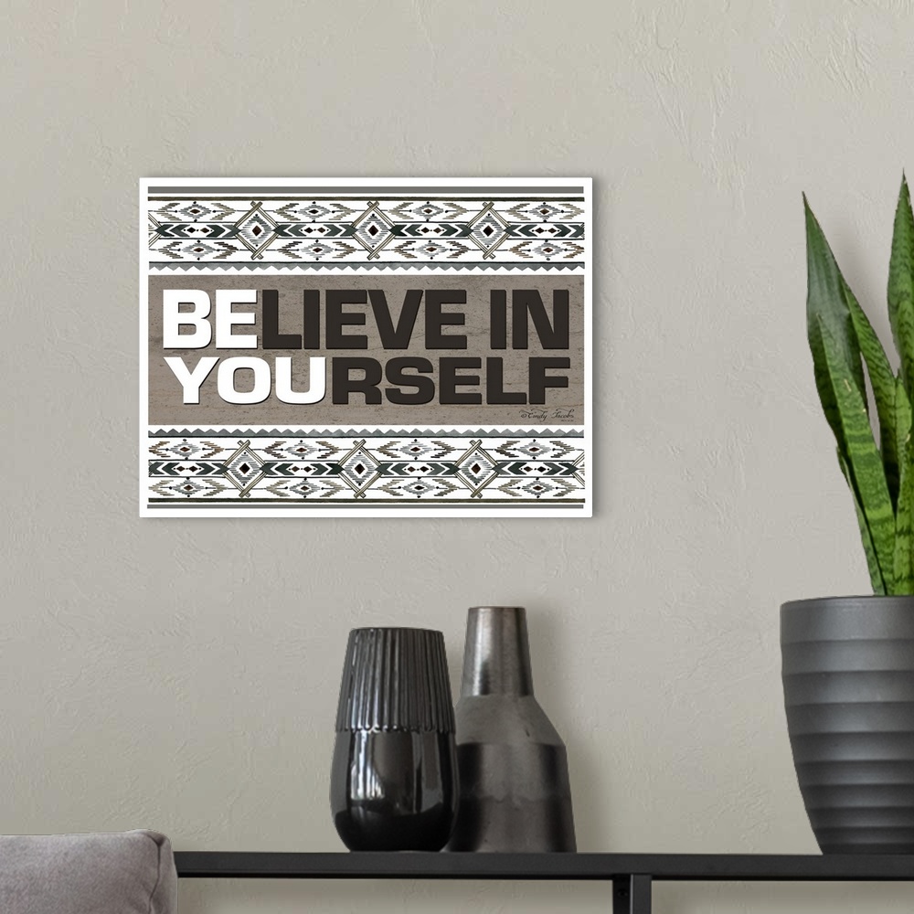 A modern room featuring Decorative artwork featuring geometric southwestern designs and the words: Believe in yourself/Be...