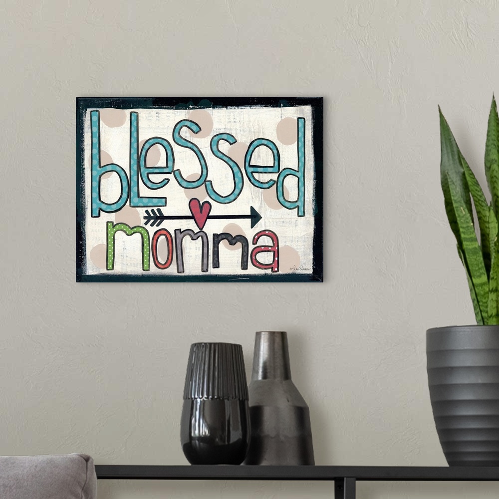 A modern room featuring Handwritten typography art reading "blessed momma," with an arrow and heart motif.