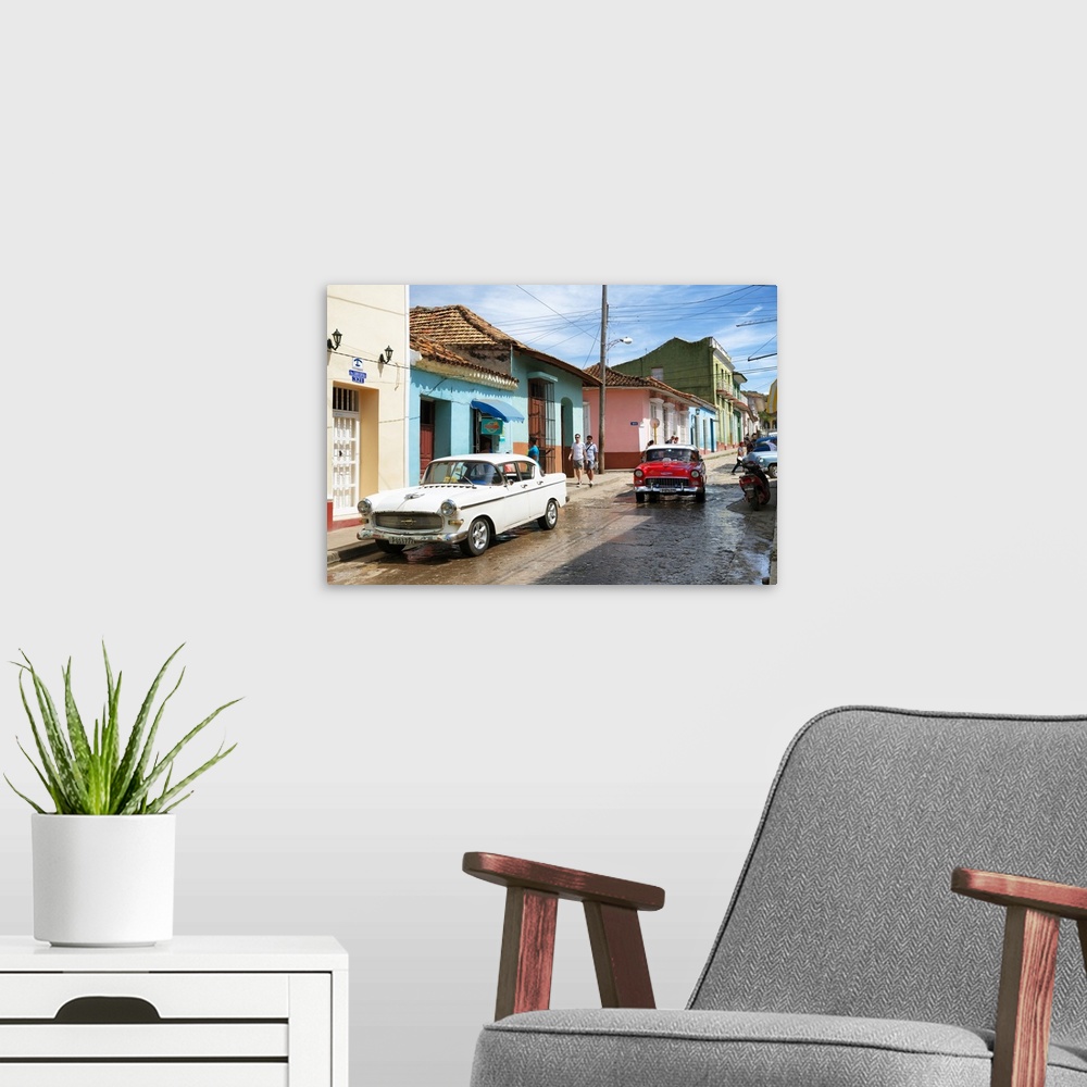 A modern room featuring Photograph of a busy Cuban street scene with vintage cars.