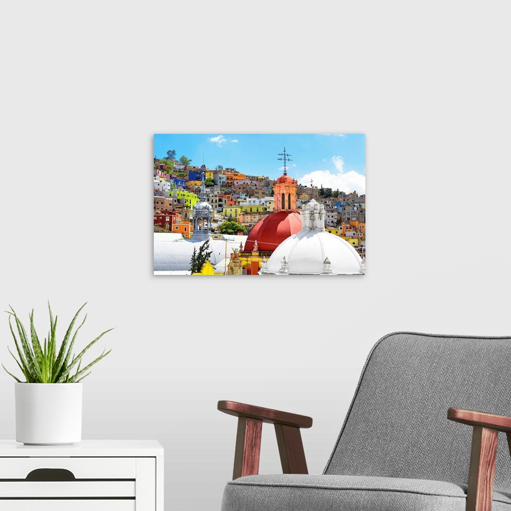 A modern room featuring Photograph of a Guanajuato, Mexico, cityscape displaying colorful buildings, homes, and church do...