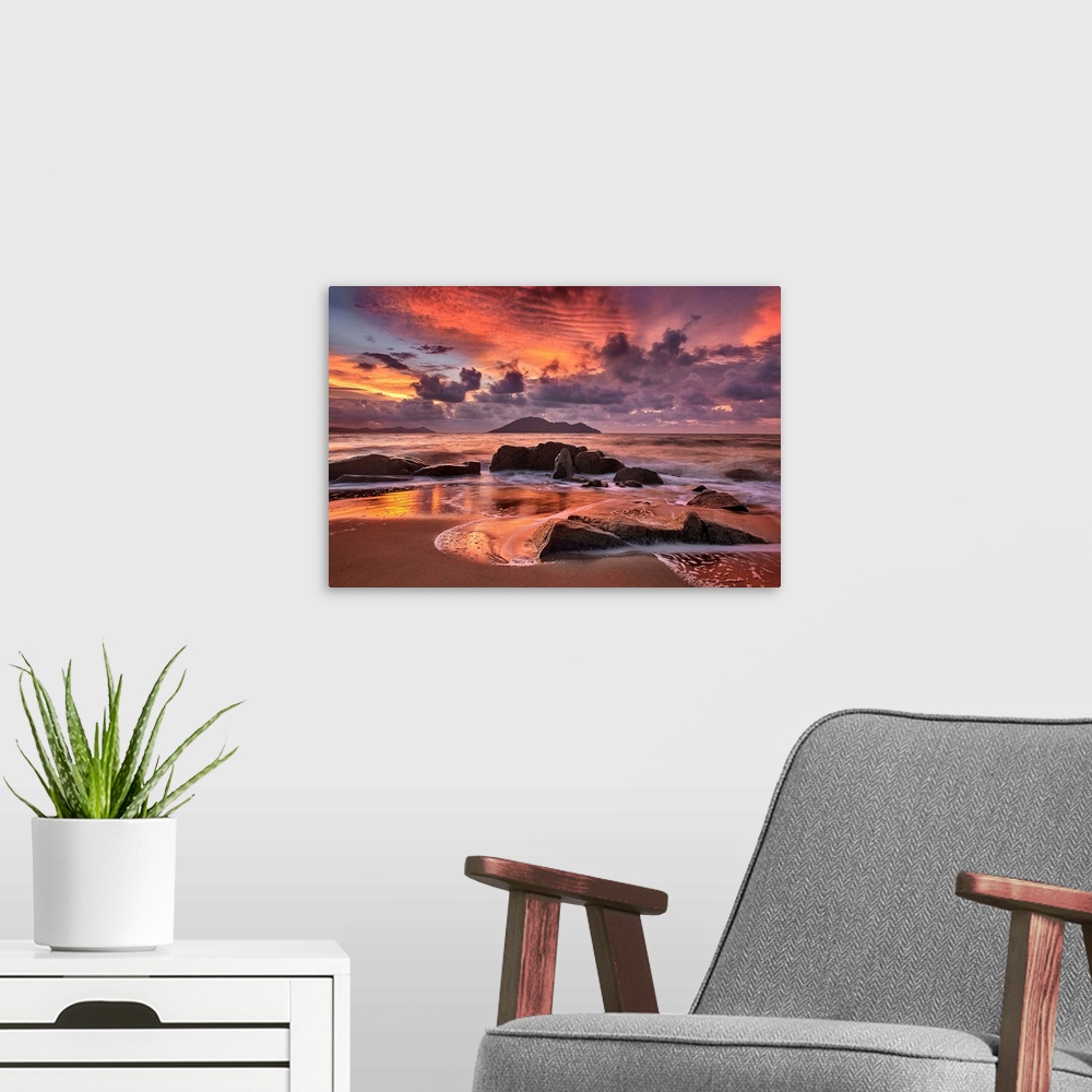 A modern room featuring Rocky beach at sunset, with dramatic clouds looming in the distance.