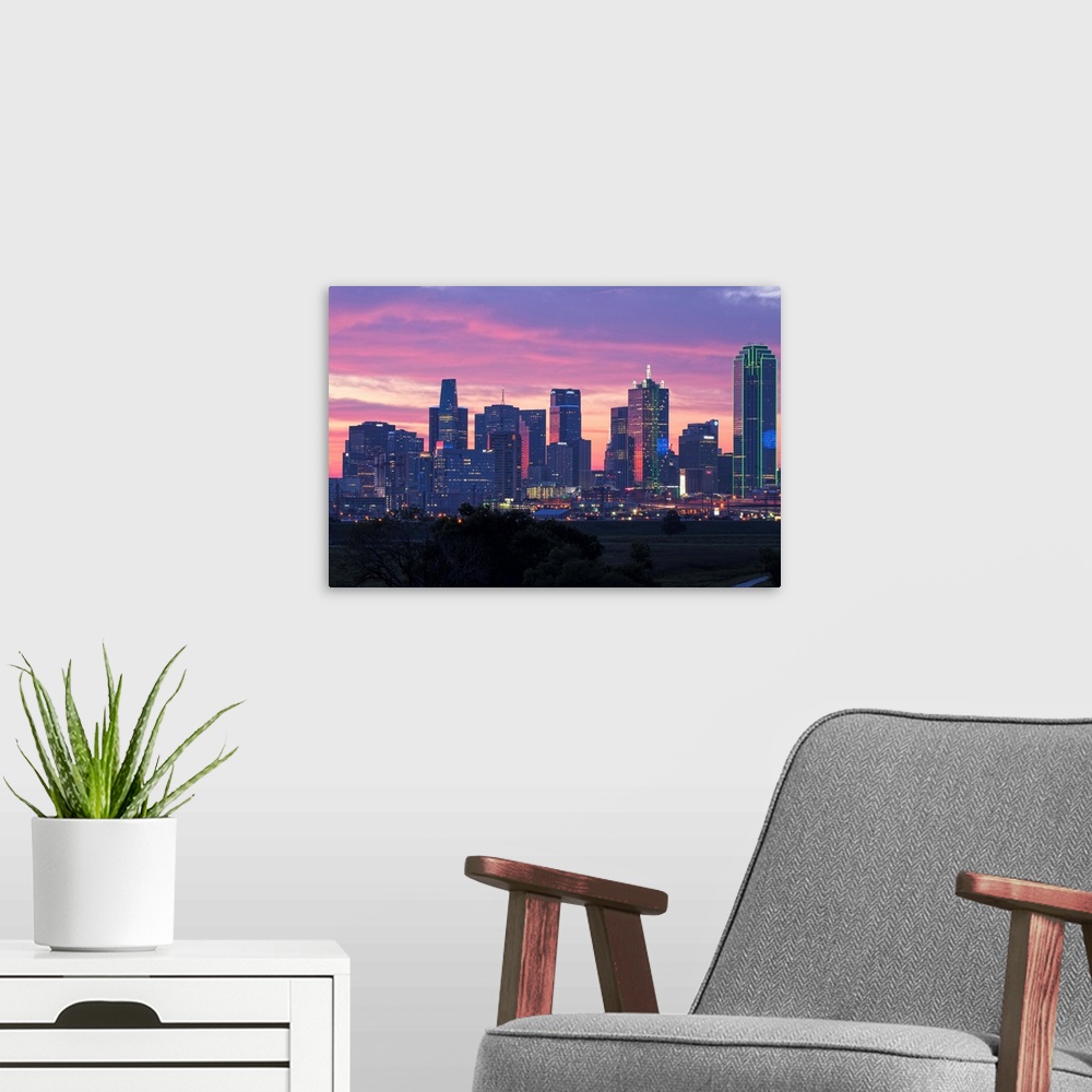 A modern room featuring A horizontal image of the Dallas, Texas city skyline at sunset