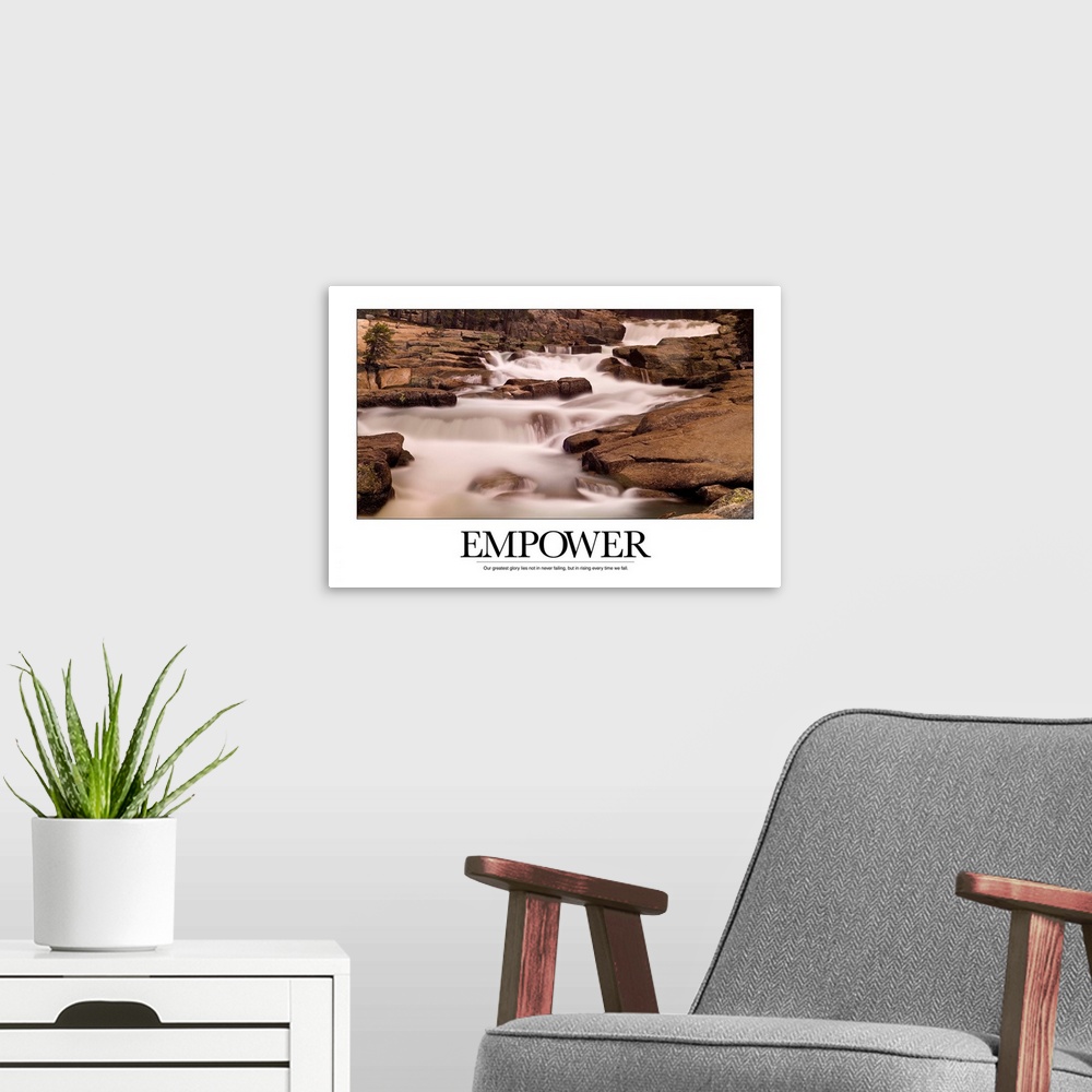 A modern room featuring Motivational poster depicting a stream flowing through rocks with the text, "Empower: Our greates...